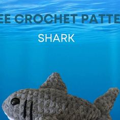 a stuffed shark in the water with text overlay that reads free crochet pattern shark