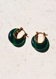 Introducing our enchanting A Thousand Island Earrings - a mesmerising homage to the lush beauty of nature, crafted with the finest deep green emerald. These curve-shaped earrings with mini gold hoops are wearable treasures inspired by the verdant islands, the tranquillity of a hidden paradise, and the timeless allure of nature's wonders. Material: Stainless Steel Waterproof: Yes Hypoallergenic: Suitable for sensitive skin Durability: Non-tarnish Each of our products is beautifully packaged in an Modern Green Round Earrings, Green Emerald Round Earrings, Elegant Green Emerald Hoop Earrings, Modern Green Round Hoop Earrings, Modern Green Hoop Earrings As Gift, Small Hoop Earrings For May Birthstone, Green Teardrop Hoop Earrings For May Birthstone, Elegant Green Hoop Earrings, Modern Small Green Hoop Earrings