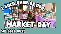 a woman kneeling down in front of a market day sign with the words sold over $ 2, 500