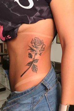 a woman with a rose tattoo on her stomach