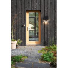 a wooden building with a door and light on it