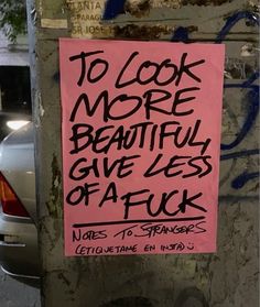 a pink sign that says to look more beautiful give less affick written on it