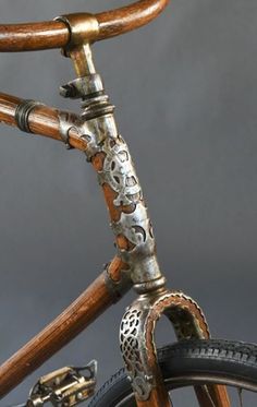 a close up of the handle bars on a bike with wood and metal details,