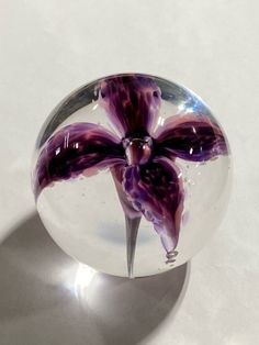 a glass ball with a flower painted on it