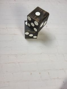 a black and white dice sitting on top of a table