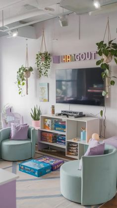 a living room filled with lots of furniture and plants hanging from the ceiling above it