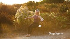 a woman sitting on top of a white surfboard in the middle of a field