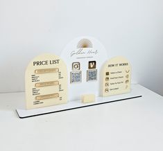 the price list is displayed on a white counter top with gold accents and other items