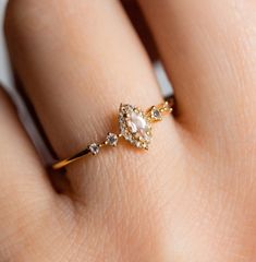 a woman's hand with a diamond ring on it