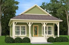 the small house is painted green and has white trim on it's front porch