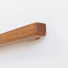 a wooden handle on a white wall