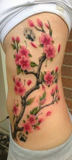 a woman's thigh with pink flowers on it