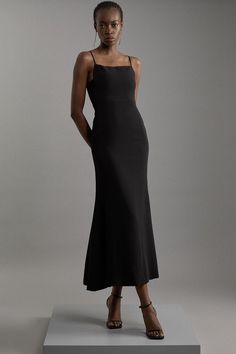 Delivering A Combination Of Dressed-Down Glamour And Statement Style, Discover Collections: 06 Partywear. Experience Elevated Elegance Our Tailored Maxi Dress, With A Sleek, Minimal Design, A Squared Neckline, And Strappy Shoulders. Pair This Piece With Strappy Heels For An Outfit Perfect For Race Days And Formal Occasions. Compact Stretch Viscose Tailored Square Neck Maxi Dress High Quality Stretch Fabric Sleek Design Uniquely Angular Squared Neckline Floor Grazing, Maxi Length Adjustable Spagh Sleek Fitted Cocktail Maxi Dress, Formal Fitted Maxi-length Slip Dress, Formal Fitted Bias Cut Backless Dress, Formal Fitted Backless Bias Cut Dress, Sleek Fitted Evening Slip Dress, Fitted Maxi Length Slip Dress For Evening, Fitted Midi-length Cocktail Gown, Fitted Evening Slip Dress Maxi Length, Fitted Midi Length Slip Dress For Gala