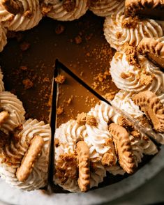 a cake with white frosting and cookies on top