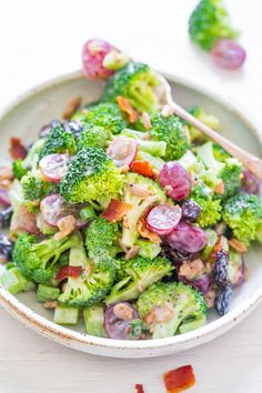 a white bowl filled with broccoli and other vegetables