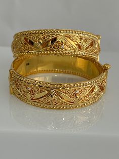 Luxury Gold Plated Bollywood Jewelry, 22k Yellow Gold Bracelets For Anniversary, Elegant Gold-plated Bracelet For Festivals, Luxury Gold Plated Bracelets For Ceremonial Occasions, 22k Gold Filigree Wedding Bracelets, 22k Gold Bracelet With Intricate Design, Elegant 22k Gold Bracelets For Festive Occasions, Luxury 22k Gold Hand Set Bangle, Traditional Yellow Gold Bracelets For Anniversary