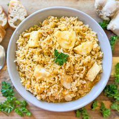 a white bowl filled with rice and sliced banana's on top of a wooden table