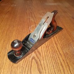 a wooden table with a metal object on it