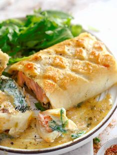 a white plate topped with meat and vegetable enchiladas