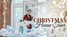 a woman standing in front of a table with white dishes on it and the words christmas house tour