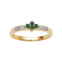 a gold ring with green and white stones