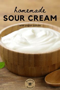 homemade sour cream with yogurt in a wooden bowl and spoon on the side