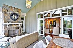 an outdoor living area with furniture and fireplace