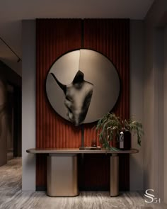 a round mirror hangs on the wall above a table with a plant in front of it