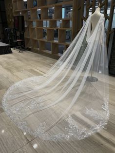 a white veil is hanging on a mannequin's head in a store