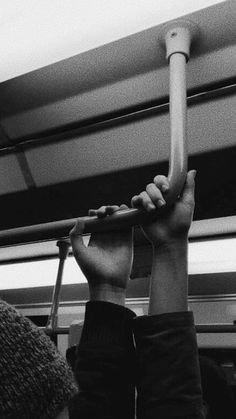 a person holding onto a pole on a bus