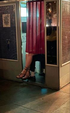 a woman is standing in an elevator with her feet on the ground and wearing high heels