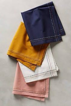 five different colored napkins sitting on top of each other