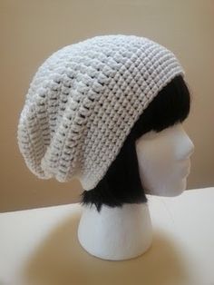 a white knitted hat on top of a mannequin head with black hair