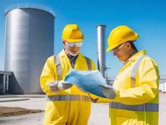 two men in yellow safety suits standing next to each other