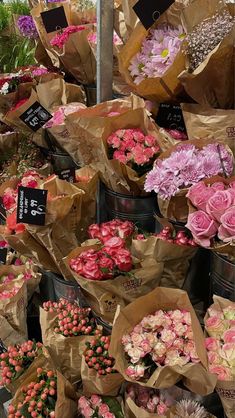 many different types of flowers in brown paper bags