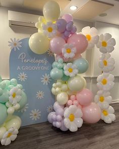 balloons are arranged in the shape of flowers and daisies