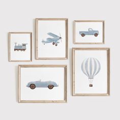 four framed pictures with cars and hot air balloons hanging on the wall in front of them