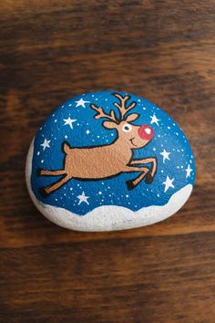 a rock with a reindeer painted on it