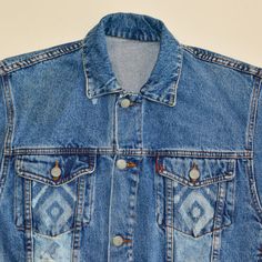 a blue jean jacket with diamonds on it