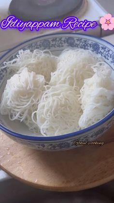 a bowl filled with noodles on top of a wooden table