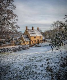 a house in the middle of a snowy field