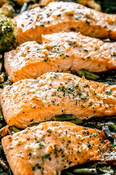 salmon and asparagus in a pan with seasoning on the top, ready to be cooked