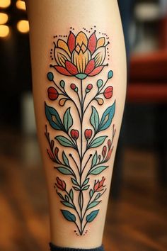 a woman's leg with a flower tattoo on it