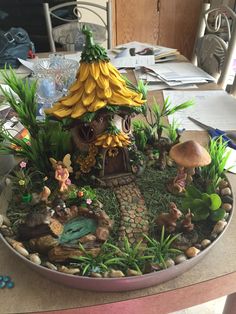 there is a small garden in the middle of a table with mushrooms and plants on it