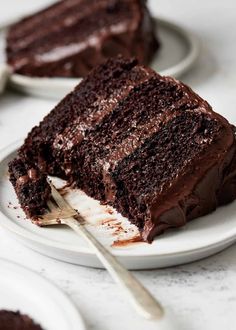 a slice of chocolate cake on a plate with a fork