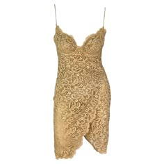 Presenting a stunning tan lace Donna Karan mini slip dress. From the Spring/Summer 1995 collection, the dress features intricate floral lace, a scalloped hem, a gracefully outlined bust, spaghetti straps, and a faux wrap detail. Made complete with the original brand tags still attached, this simply fabulous and irresistibly sexy vintage runway dress is a must-have! Approximate measurements: Size - 6 Bust: 28" - 34" Waist: 26" - 30" Hips: 38" - 44" Shoulder to hem: 34" 60% Cotton, 35% Rayon, 5% Nylon Elegant Mini Dress With Scalloped Edges For Party, Elegant Scalloped Edges Mini Dress For Party, Lace Slip Dress For Party, Delicate Lace Slip Dress For Party, Elegant Party Mini Dress With Scalloped Edges, Lace Slip Dress With Lace Trim For Party, Lace Trim Slip Dress For Party, Evening Fitted Lace Dress With Scalloped Edges, Party Lace Slip Dress With Lace Trim