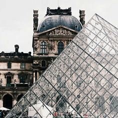 a large glass pyramid sitting in front of a building