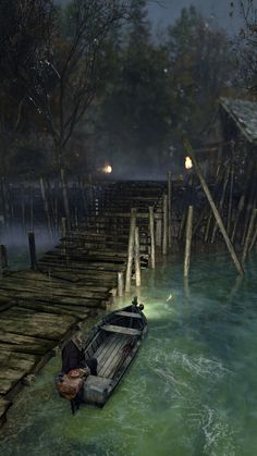 a man is sitting on a boat in the water by a dock at night time