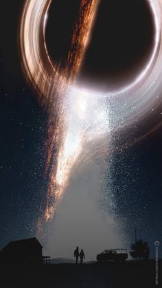 two people standing in front of a black hole