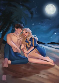 a man and woman are sitting on the beach at night